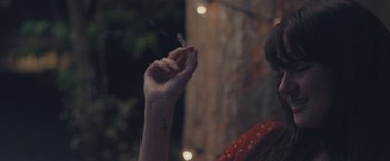 Movie still from “Endings, Beginnings” (2019), directed by Drake Doremus – A woman holding a cigarette in her hand; Close Up shot, Over the shoulder angle
