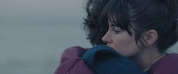 Movie still from “Endings, Beginnings” (2019), directed by Drake Doremus – A person wearing a purple jacket; Extreme Close Up shot, Over the shoulder angle