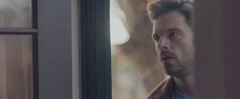 Movie still from “Endings, Beginnings” (2019), directed by Drake Doremus – A person looking out a window; Close Up shot, Over the shoulder angle