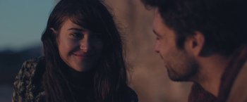 Movie still from “Endings, Beginnings” (2019), directed by Drake Doremus – A man and a woman smiling at each other; Close Up shot, Over the shoulder angle