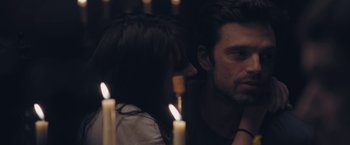 Movie still from “Endings, Beginnings” (2019), directed by Drake Doremus – A man and a woman sitting in front of lit candles; Close Up shot, Over the shoulder angle