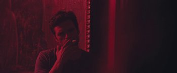 Movie still from “Endings, Beginnings” (2019), directed by Drake Doremus – A man smoking a cigarette in front of a mirror; Close Up shot, Low angle