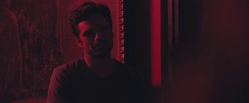 Movie still from “Endings, Beginnings” (2019), directed by Drake Doremus – A man standing in front of a red light; Close Up shot, Over the shoulder angle