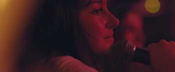 Movie still from “Endings, Beginnings” (2019), directed by Drake Doremus – A person with a microphone; Extreme Close Up shot, Low angle