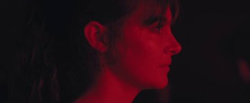 Movie still from “Endings, Beginnings” (2019), directed by Drake Doremus – A person's face in a dark room; Close Up shot, Low angle
