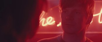 Movie still from “Endings, Beginnings” (2019), directed by Drake Doremus – A man is looking into the camera with a blurry background; Close Up shot, Over the shoulder angle