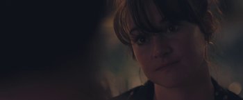 Movie still from “Endings, Beginnings” (2019), directed by Drake Doremus – A woman's face in the dark; Close Up shot, Over the shoulder angle