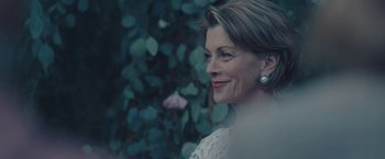 Movie still from “Endings, Beginnings” (2019), directed by Drake Doremus – A person wearing a white dress; Close Up shot, Over the shoulder angle