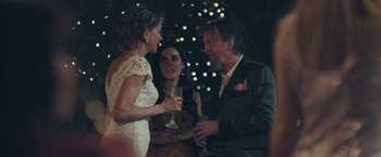 Movie still from “Endings, Beginnings” (2019), directed by Drake Doremus – Two women and a man standing next to each other; Medium shot, Over the shoulder angle