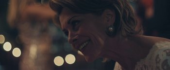 Movie still from “Endings, Beginnings” (2019), directed by Drake Doremus – A woman's face with lights in the background; Close Up shot, Over the shoulder angle