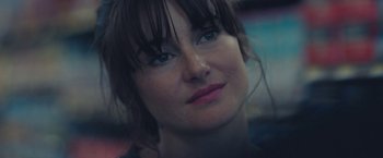 Movie still from “Endings, Beginnings” (2019), directed by Drake Doremus – A woman's face in a dark room; Close Up shot, Over the shoulder angle