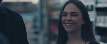 Movie still from “Endings, Beginnings” (2019), directed by Drake Doremus – A person smiling for the camera; Close Up shot, Over the shoulder angle