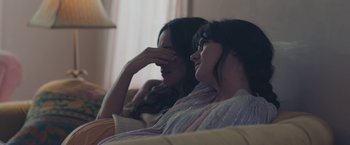 Movie still from “Endings, Beginnings” (2019), directed by Drake Doremus – Two women sitting on a couch looking at each other; Close Up shot, High angle