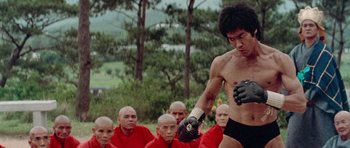 Movie still from “Enter the Dragon” (1973), directed by Robert Clouse – A group of men in red shirts and black gloves; Medium shot, Low angle