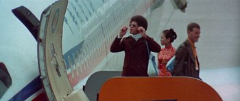 Movie still from “Enter the Dragon” (1973), directed by Robert Clouse – A man and a woman standing next to each other; Medium shot, Low angle