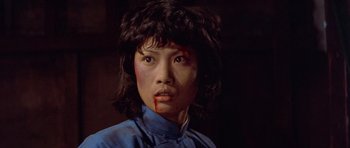 Movie still from “Enter the Dragon” (1973), directed by Robert Clouse – A young woman with blood all over her face; Close Up shot, Low angle