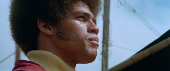 Movie still from “Enter the Dragon” (1973), directed by Robert Clouse – A man's face looking up; Close Up shot, Low angle