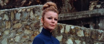 Movie still from “Enter the Dragon” (1973), directed by Robert Clouse – A woman in a blue shirt with a bun in her hair; Close Up shot, Low angle