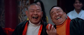 Movie still from “Enter the Dragon” (1973), directed by Robert Clouse – A couple of people that are laughing at something; Close Up shot, Low angle