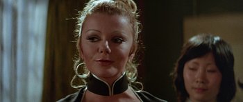 Movie still from “Enter the Dragon” (1973), directed by Robert Clouse – A person wearing a black and white collar; Close Up shot, Low angle