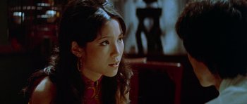 Movie still from “Enter the Dragon” (1973), directed by Robert Clouse – A woman with long dark hair sitting in a chair; Close Up shot, Over the shoulder angle