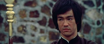 Movie still from “Enter the Dragon” (1973), directed by Robert Clouse – A person wearing a suit and tie; Close Up shot, Low angle