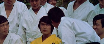 Movie still from “Enter the Dragon” (1973), directed by Robert Clouse – A group of young men standing next to each other; Close Up shot, Over the shoulder angle