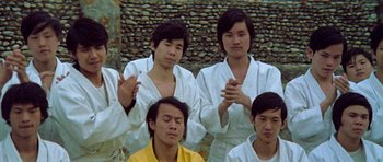 Movie still from “Enter the Dragon” (1973), directed by Robert Clouse – A group of young men standing next to each other; Medium shot, High angle