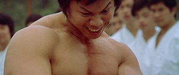 Movie still from “Enter the Dragon” (1973), directed by Robert Clouse – A man's chest and chest muscles; Close Up shot, Low angle