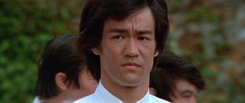 Movie still from “Enter the Dragon” (1973), directed by Robert Clouse – A person wearing a white shirt; Close Up shot, Low angle