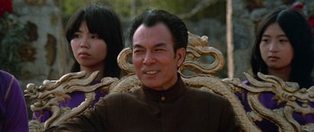 Movie still from “Enter the Dragon” (1973), directed by Robert Clouse – A man and a woman sitting next to each other; Medium shot, Low angle