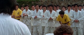 Movie still from “Enter the Dragon” (1973), directed by Robert Clouse – A group of young men standing in a line; Wide shot, Over the shoulder angle