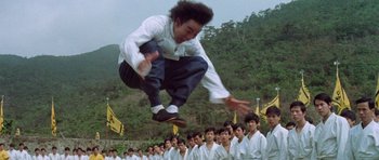 Movie still from “Enter the Dragon” (1973), directed by Robert Clouse – A man jumping in the air over a group of people; Wide shot, Low angle