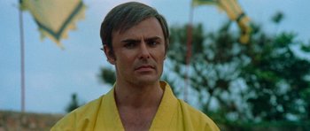 Movie still from “Enter the Dragon” (1973), directed by Robert Clouse – A person wearing a yellow robe; Close Up shot, Low angle