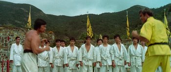 Movie still from “Enter the Dragon” (1973), directed by Robert Clouse – A group of young men standing next to each other; Wide shot, Low angle