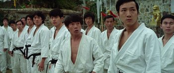 Movie still from “Enter the Dragon” (1973), directed by Robert Clouse – A group of young men standing next to each other; Medium shot, Low angle