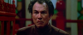 Movie still from “Enter the Dragon” (1973), directed by Robert Clouse – A person wearing a brown shirt; Close Up shot, Low angle