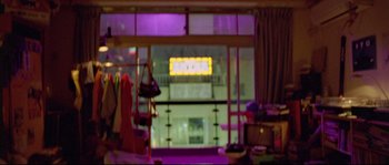 Movie still from “Enter the Void” (2009), directed by Gaspar Noé – A blurry picture of a room in a store; Wide shot, Over the shoulder angle