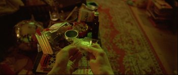 Movie still from “Enter the Void” (2009), directed by Gaspar Noé – A person lighting a cigarette on a table; Extreme Close Up shot, Overhead angle