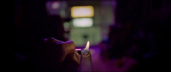 Movie still from “Enter the Void” (2009), directed by Gaspar Noé – A person lighting a candle in a dark room; Extreme Close Up shot, High angle