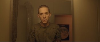 Movie still from “Enter the Void” (2009), directed by Gaspar Noé – A young man is standing in front of a mirror; Medium shot, Low angle