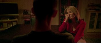 Movie still from “Enter the Void” (2009), directed by Gaspar Noé – A man and a woman sitting in front of each other; Close Up shot, Over the shoulder angle