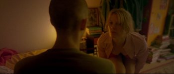 Movie still from “Enter the Void” (2009), directed by Gaspar Noé – A woman sitting in front of a mirror talking to a man; Medium shot, Over the shoulder angle