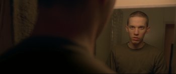 Movie still from “Enter the Void” (2009), directed by Gaspar Noé – A blurry image of a person's face in a room; Close Up shot, Over the shoulder angle