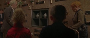 Movie still from “Enter the Void” (2009), directed by Gaspar Noé – A young boy looking into a display case with vases on it; Close Up shot, Over the shoulder angle