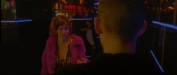 Movie still from “Enter the Void” (2009), directed by Gaspar Noé – A woman in a pink jacket talking to a man in a pink jacket; Close Up shot, Over the shoulder angle
