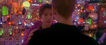 Movie still from “Enter the Void” (2009), directed by Gaspar Noé – A young boy and a girl looking at one another; Close Up shot, Over the shoulder angle