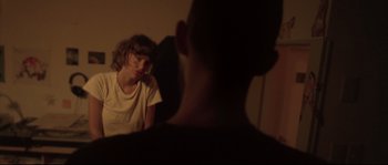 Movie still from “Enter the Void” (2009), directed by Gaspar Noé – A man and a woman sitting in a room; Close Up shot, Over the shoulder angle