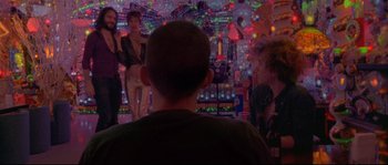A group of people standing in front of a neon sign