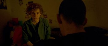 Movie still from “Enter the Void” (2009), directed by Gaspar Noé – Two people sitting at a table in front of each other; Medium shot, Over the shoulder angle